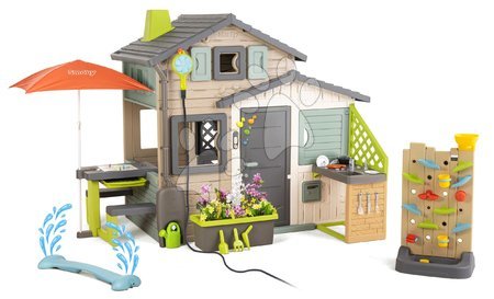 Case in set - Casetta degli Amici ecologica con giochi d'acqua accanto alla parete di gioco nei colori naturali del marrone Friends House S